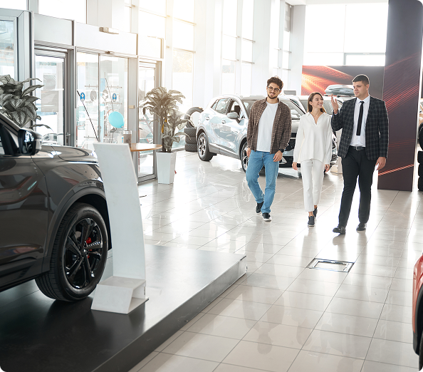 couple-choosing-new-car-with-salesman-choosing-sui-2024-10-21-17-29-49-utc